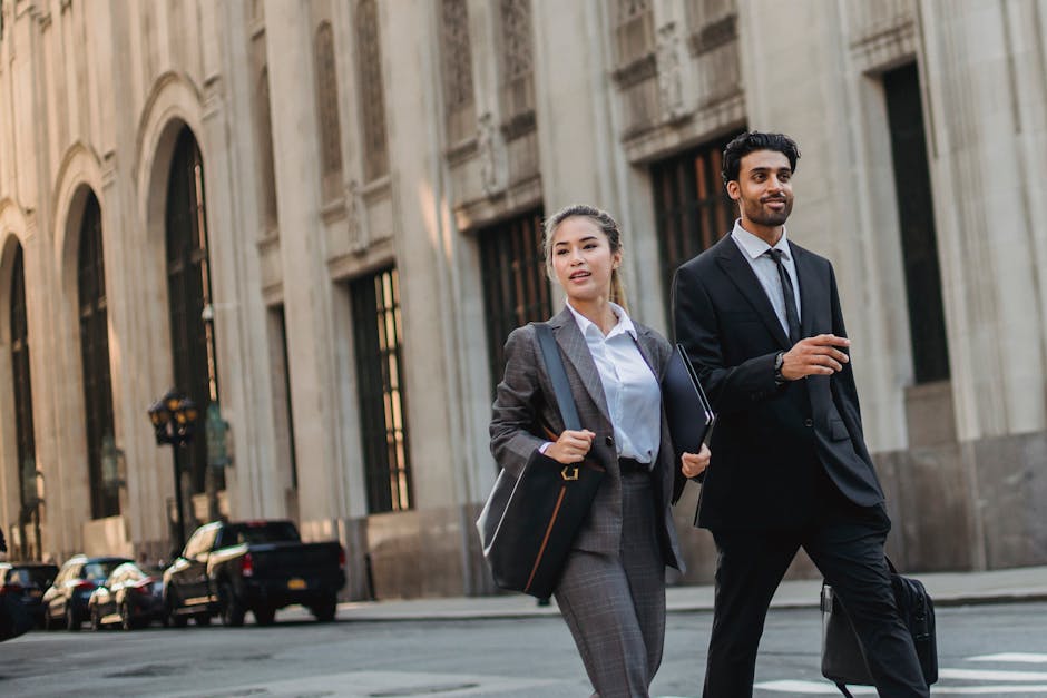 Two business professionals walking confidently on a city street